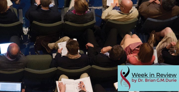 Overhead view of people sitting in chairs taking note