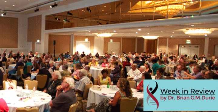 Audience sitting at tables in a convention room