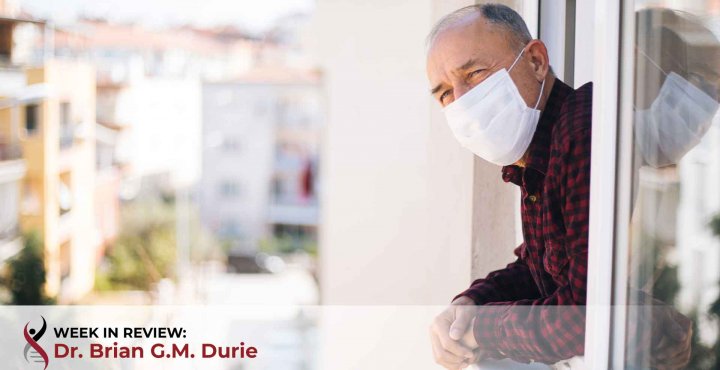 An older man leans outside his window
