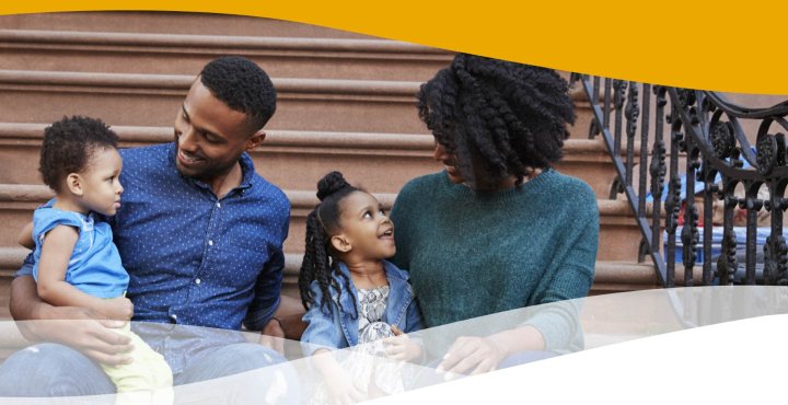 Black New Yorker family sits happily on apartment steps.