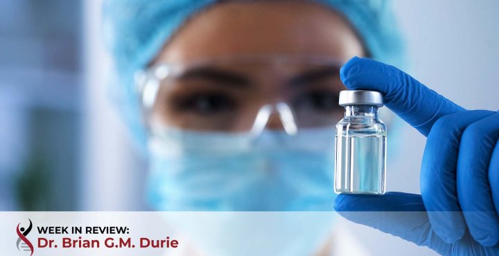 Lab technician holding vaccine vial