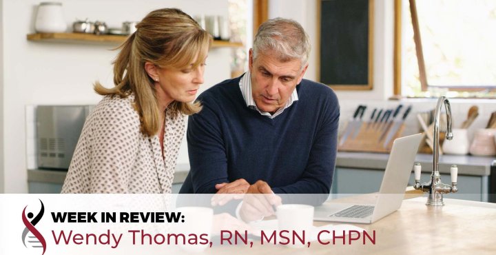 senior couple reviewing documents in front of a laptop