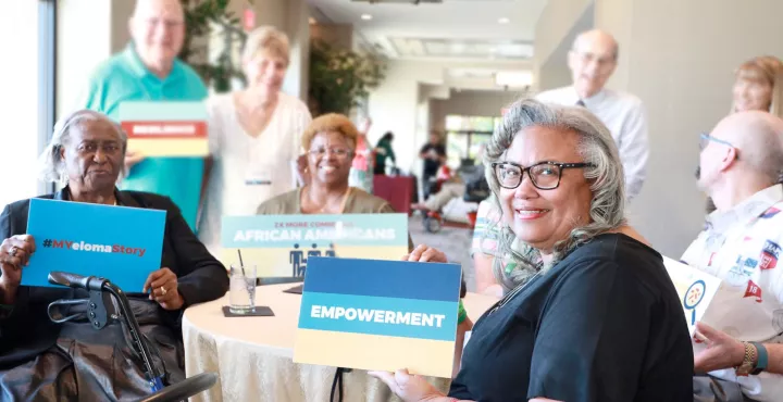 imf support group members with giving tuesday signs