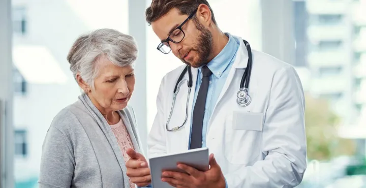 doctor shows iPad to a patient