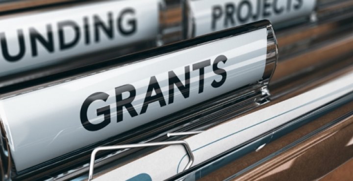 hanging file folders with tabs for "Funding" and "Grants"