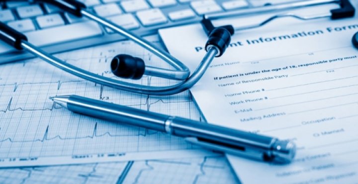 medical charts with pen and stethoscope