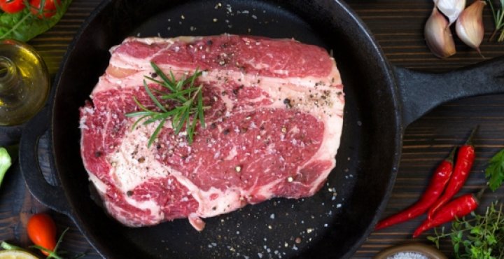 Steak and herbs on skillet