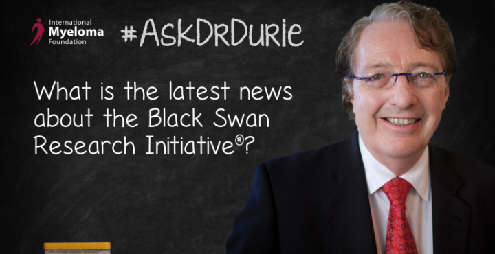 Dr. Durie in front of a chalk board
