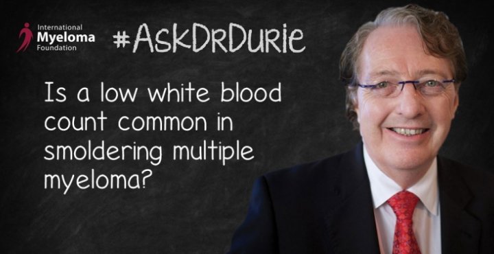 Dr. Durie in front of a chalk board