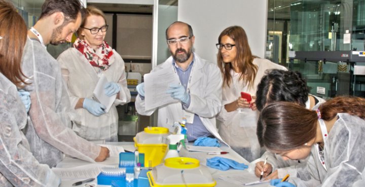Researchers gather around a table.