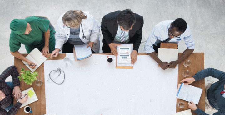 Doctors discuss and share news at table