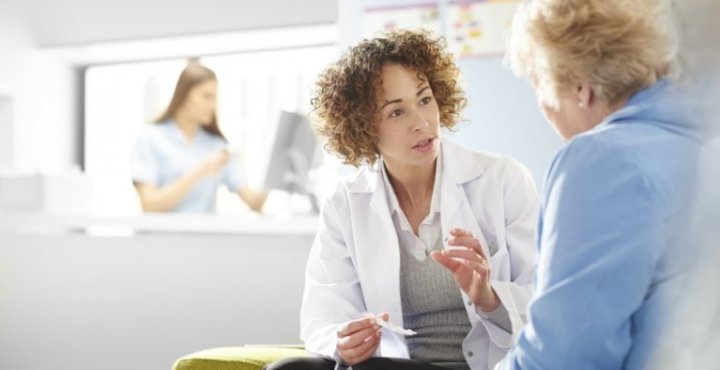 Female doctor talking to senior female patient