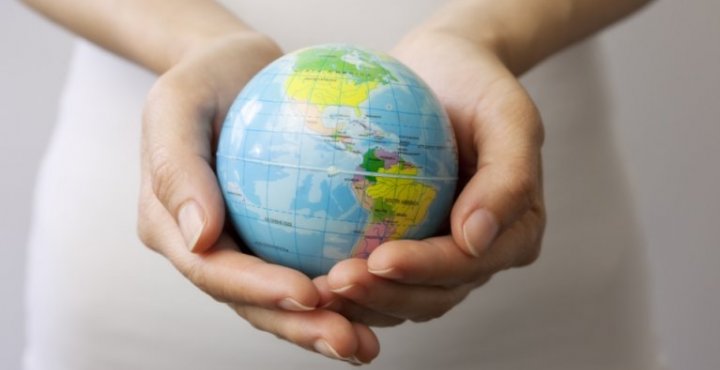A globe held in a person's hands. 