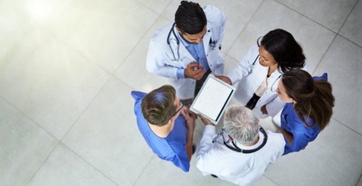 Overhead view of medical staff looking at an ipad
