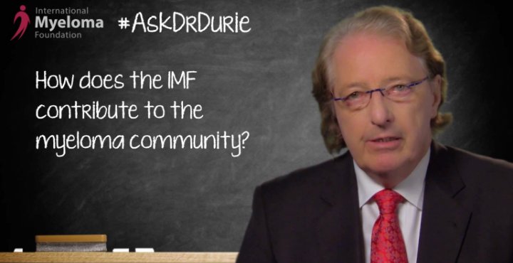 Dr. Durie in front of a chalk board