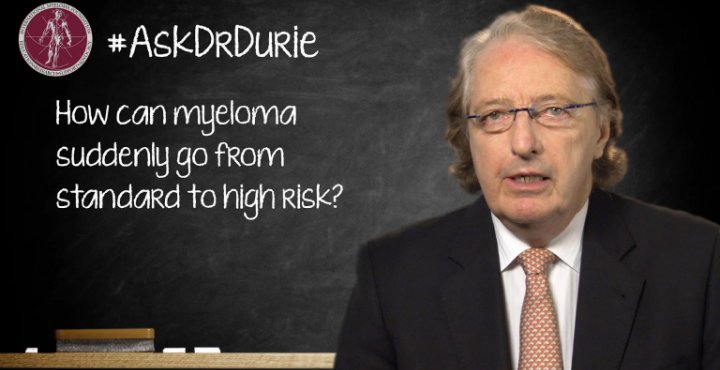 Dr. Durie in front of a chalk board