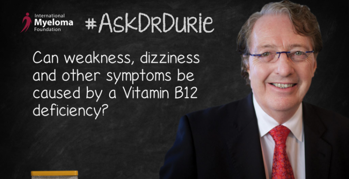 Dr. Durie in front of a chalk board