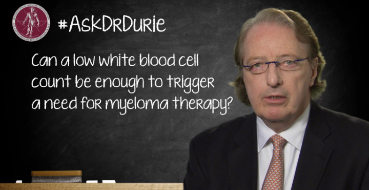 Dr. Brian G.M. Durie in front of a chalk board