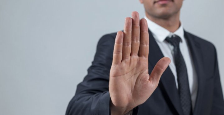 Man in business suit holding hand out, halt