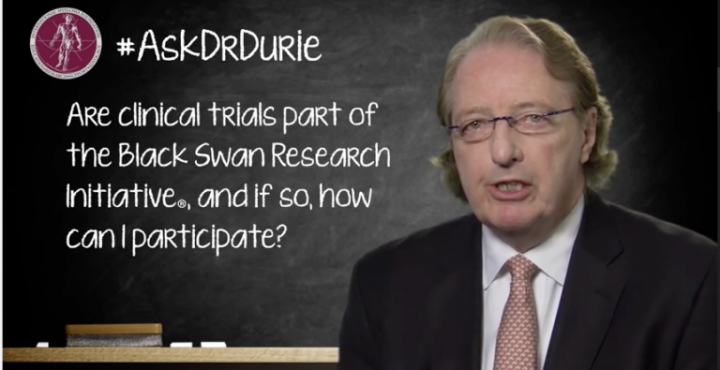 Dr. Durie in front of chalk board