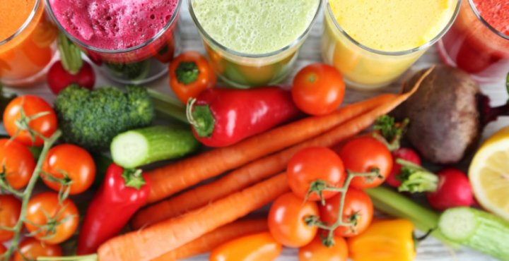 Colorful fruit smoothies and assorted vegetables