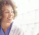 smiling doctor meets with patient