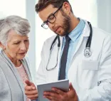 doctor shows iPad to a patient