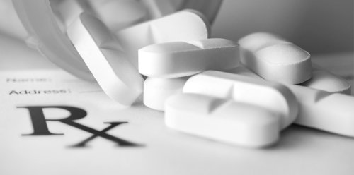 prescription pad with a bottle of pills 