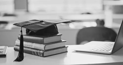 mortar board books and a computer