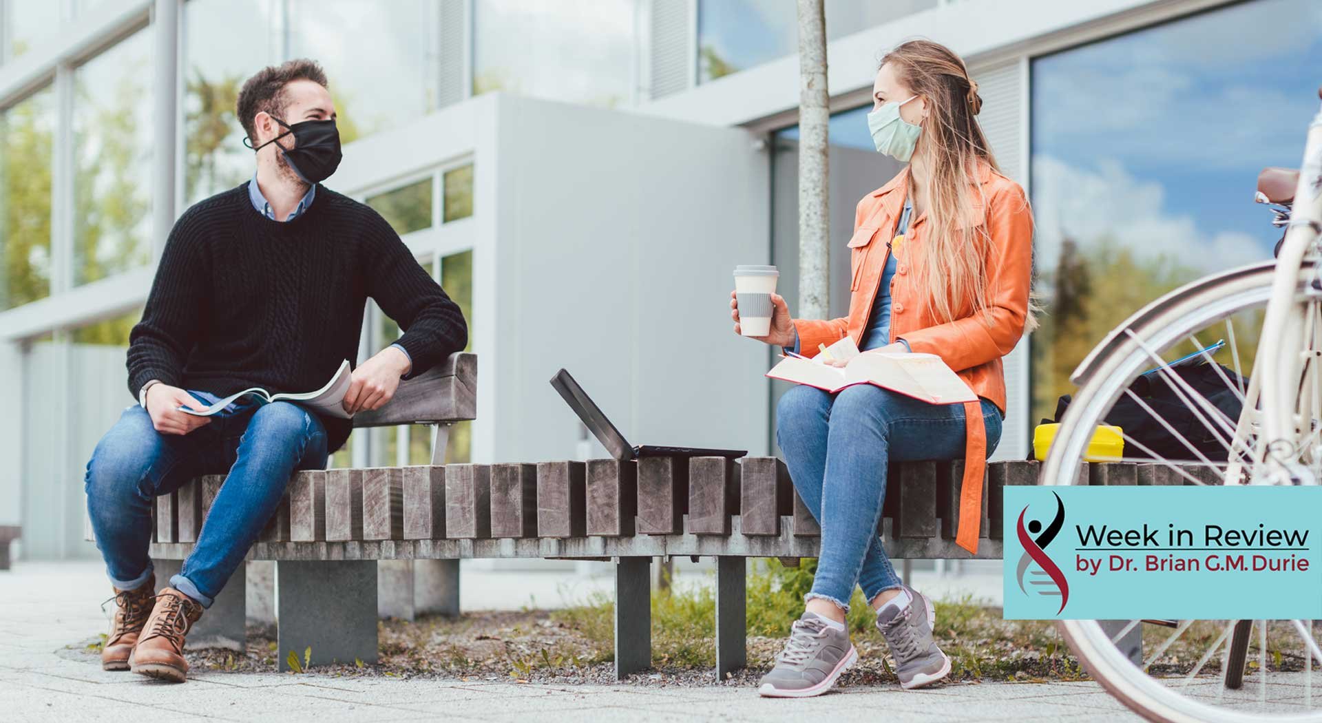 man and women on bench in masks