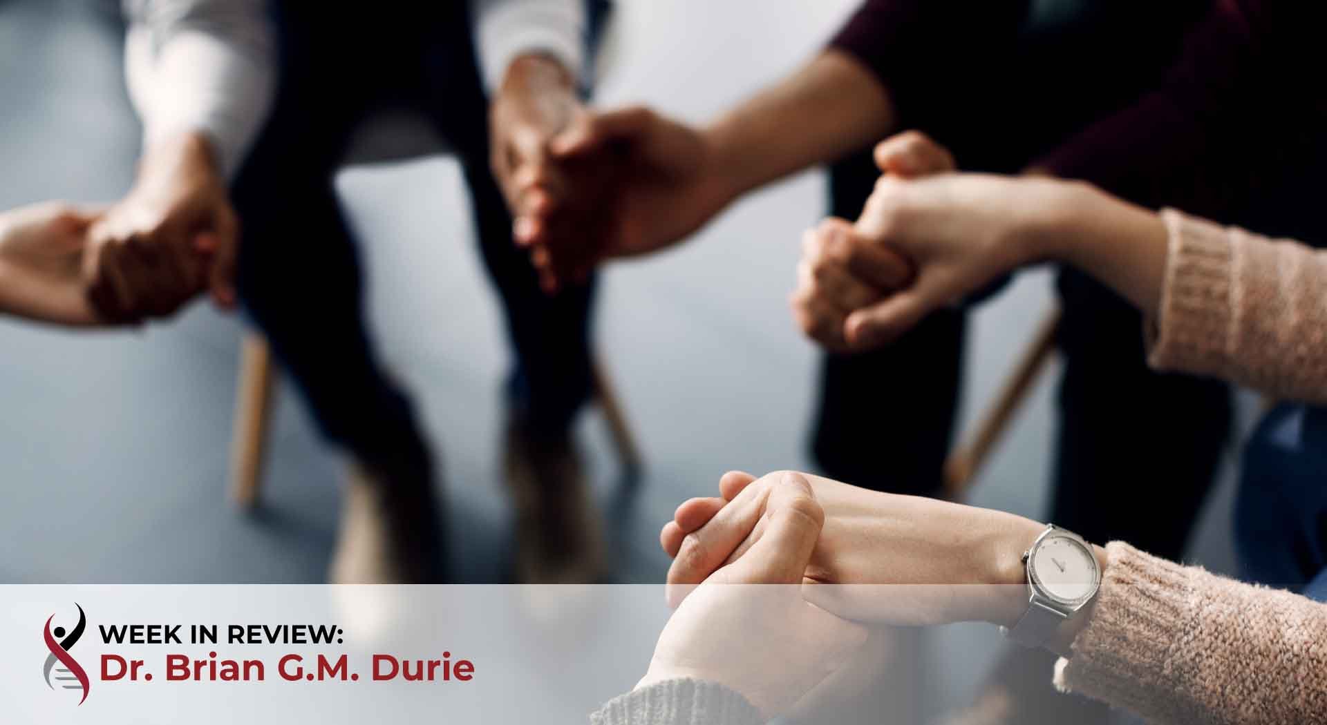 support group members holding hands during a meeting