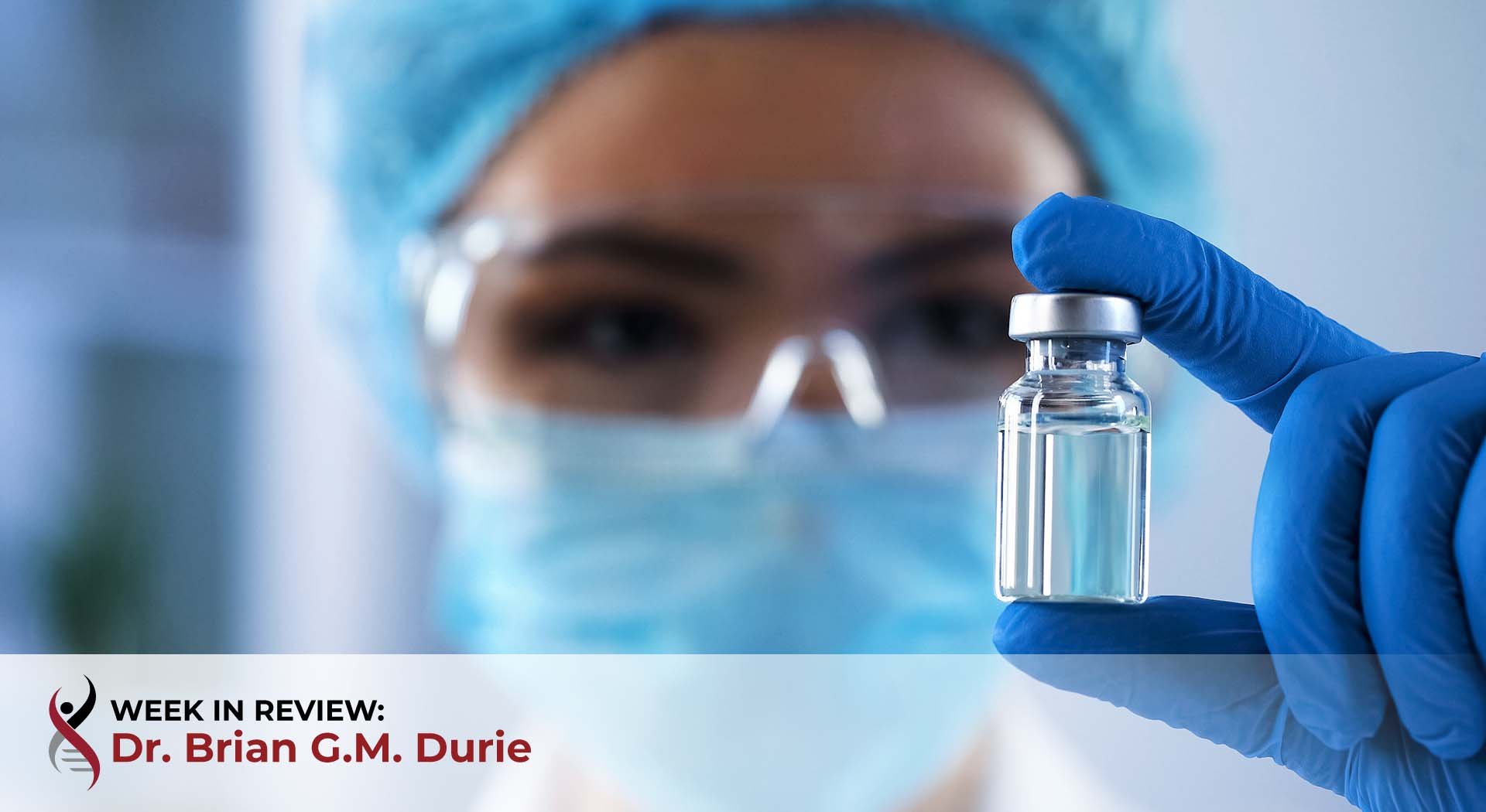 Lab technician holding vaccine vial
