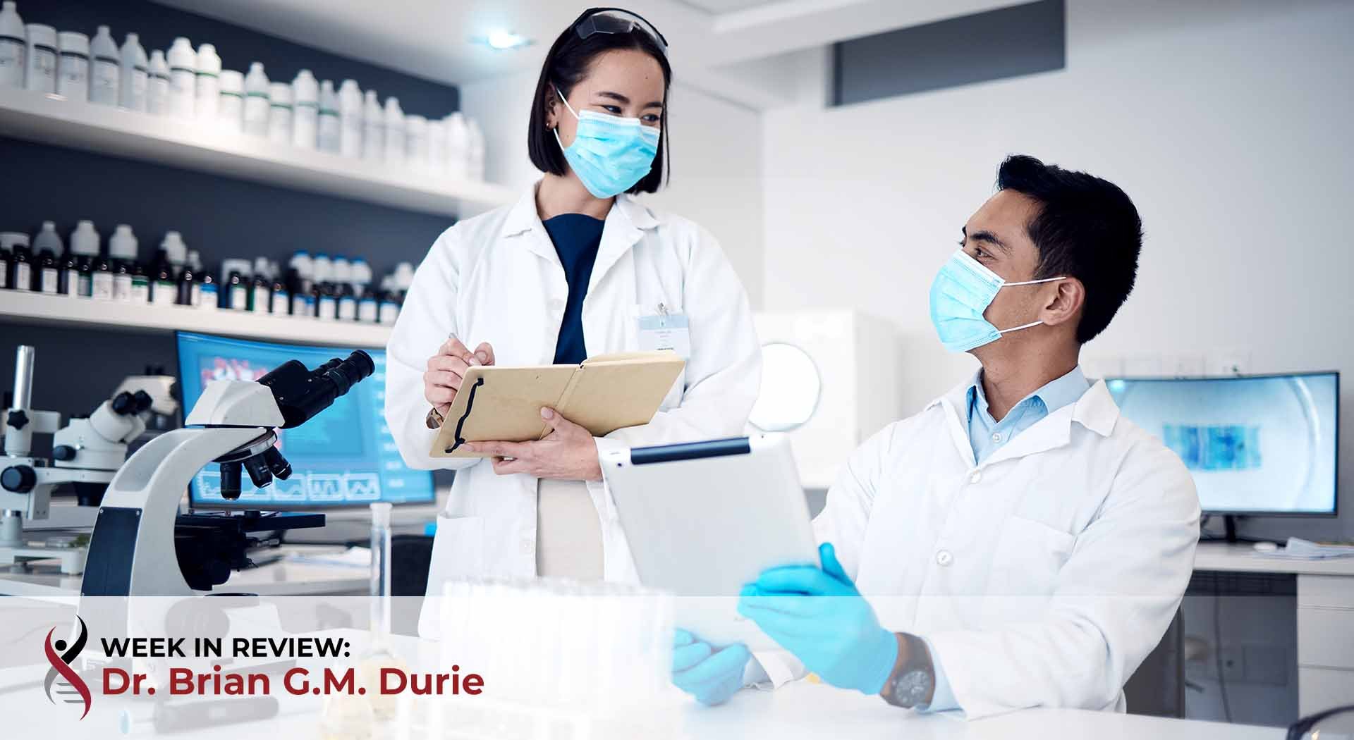 Pair of scientists analyze data in research lab