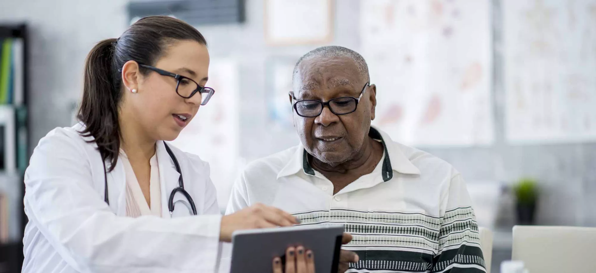 A doctor gives a patient a medical pamphlet during his doctor visit