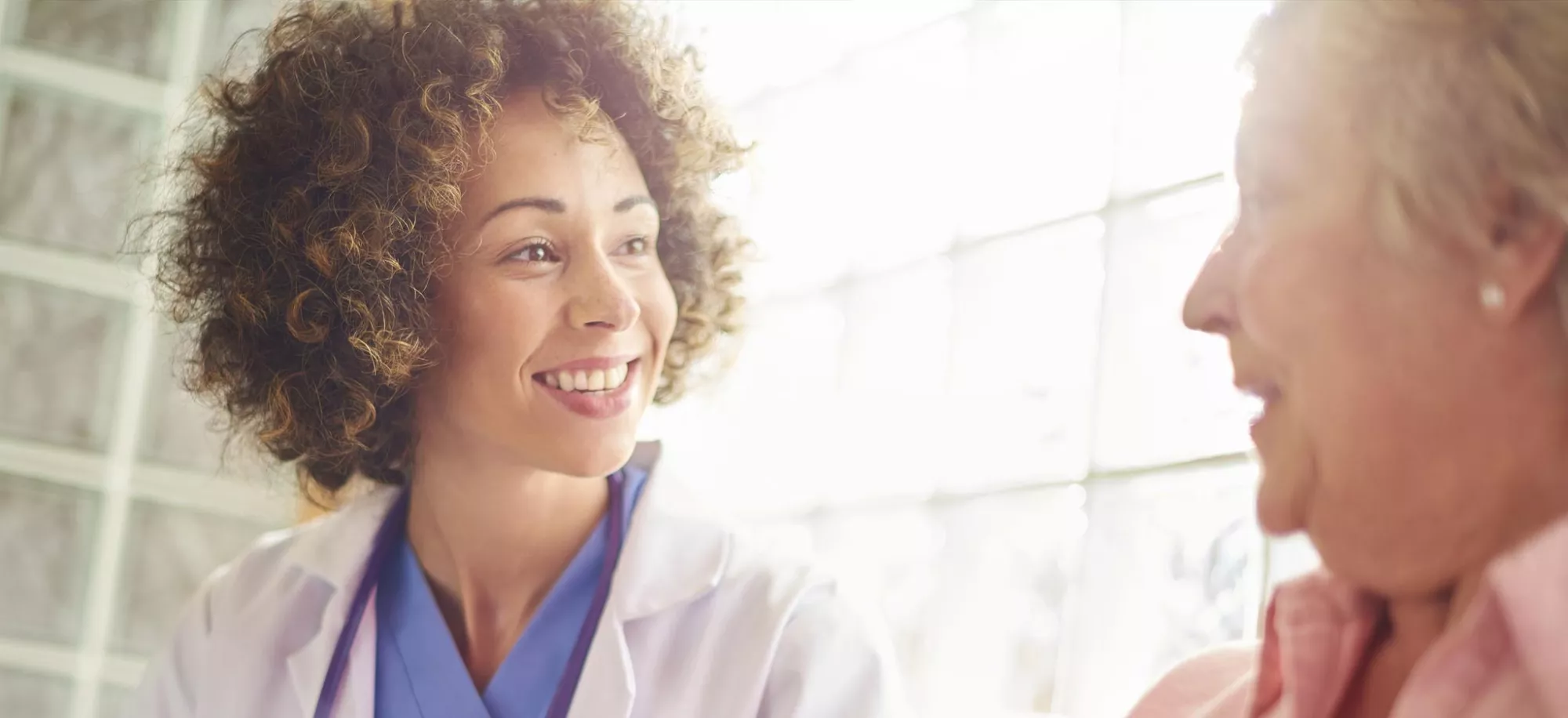 smiling doctor meets with patient