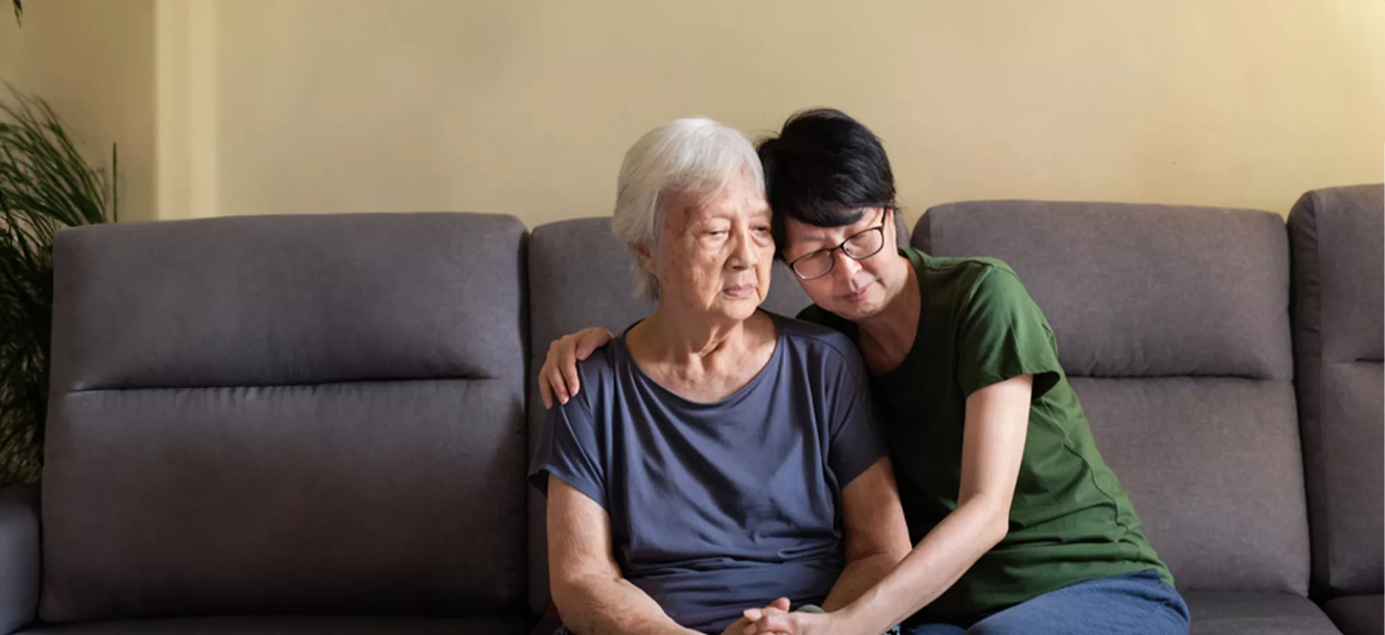 An Asian daughter comforts her Asian mother 