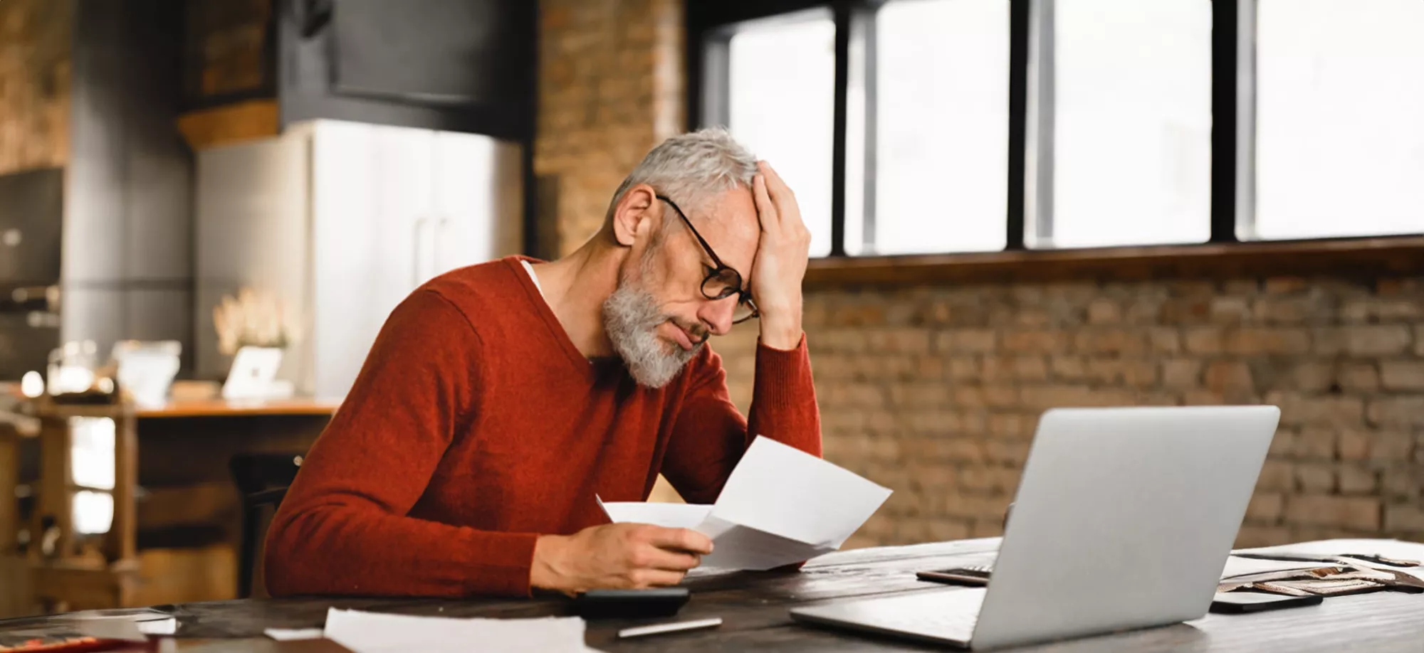 middle age white male looking at bills
