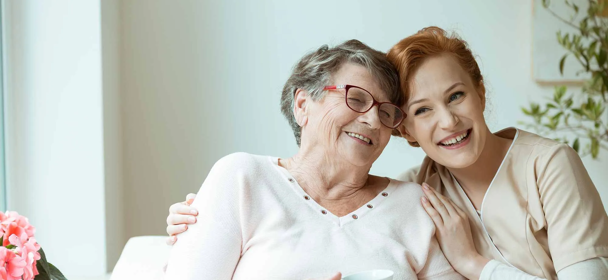A mother and her daughter share a warm embrace in the living room 