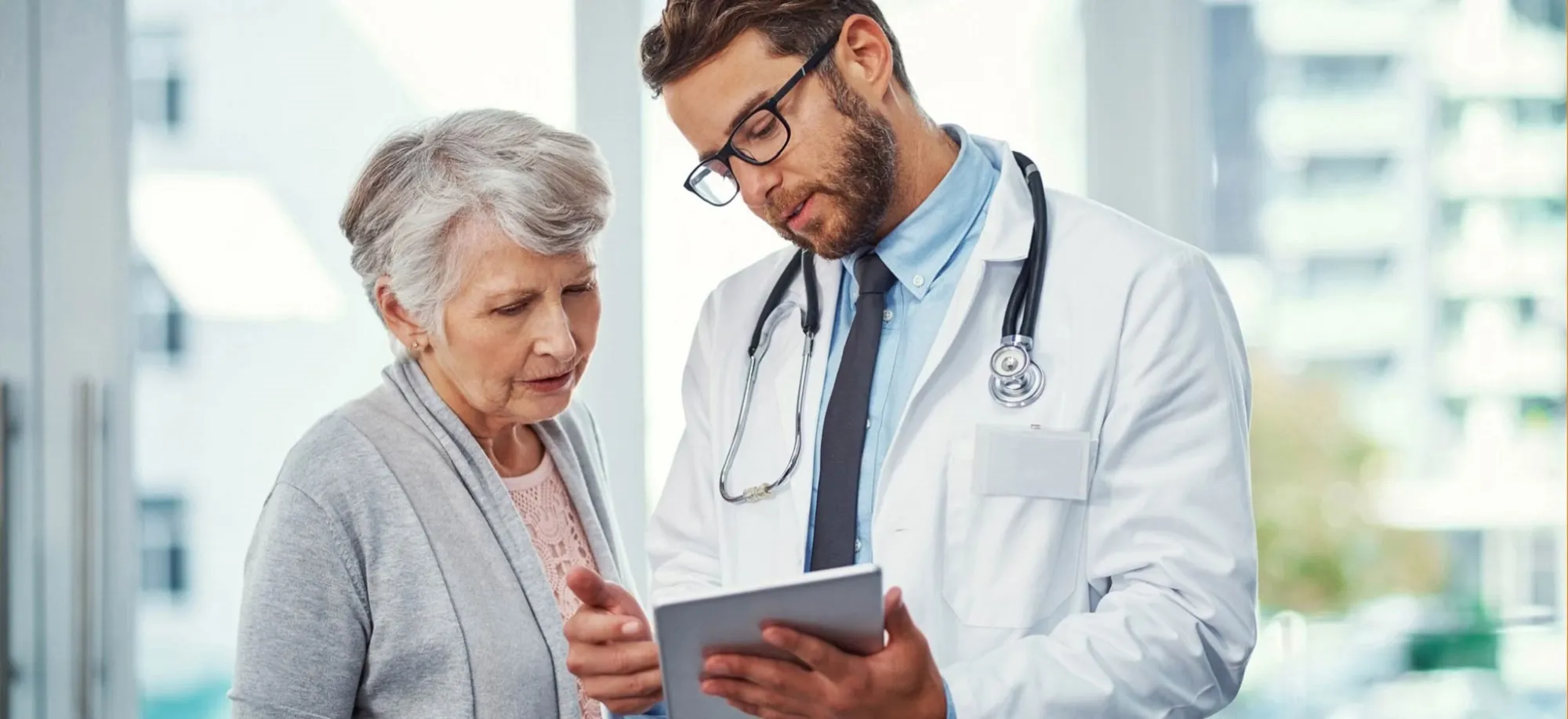 doctor shows iPad to a patient
