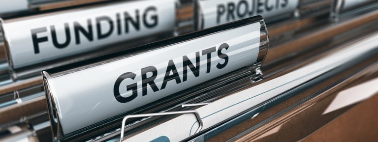 hanging file folders with tabs for "Funding" and "Grants"