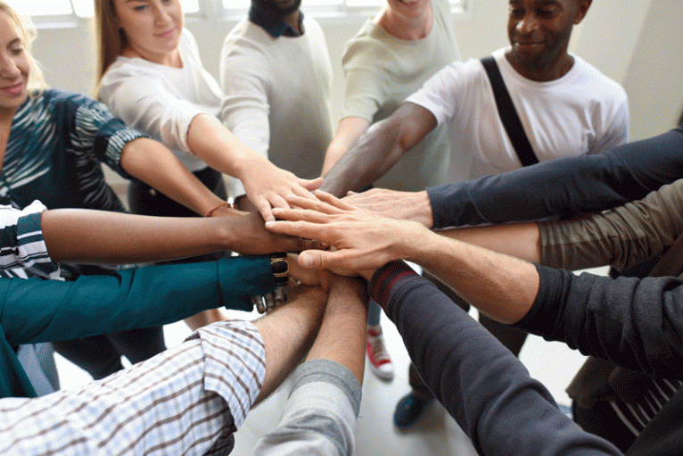 Group of people put hands in a circle