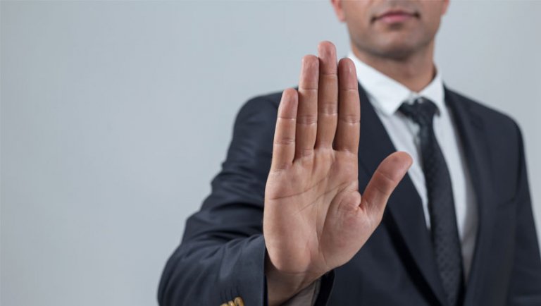 Man in business suit holding hand out, halt