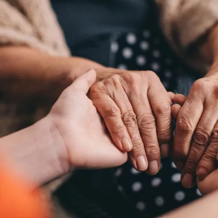 young hands holding older hands