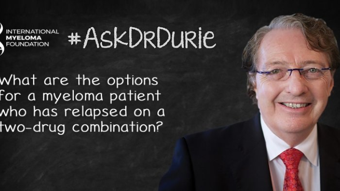 Dr. Durie in front of a chalk board
