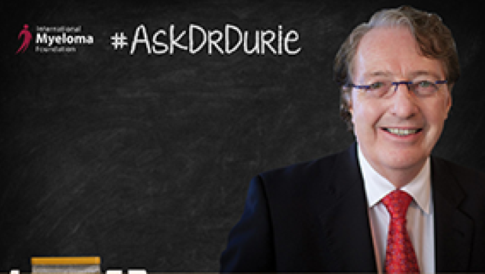 Dr, Durie in front of a chalk board