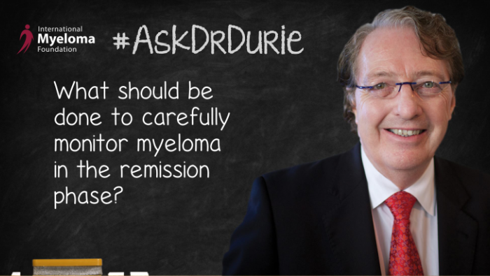 Dr. Durie in front of a chalk board