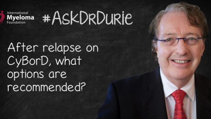 Dr. Durie in front of a chalk board