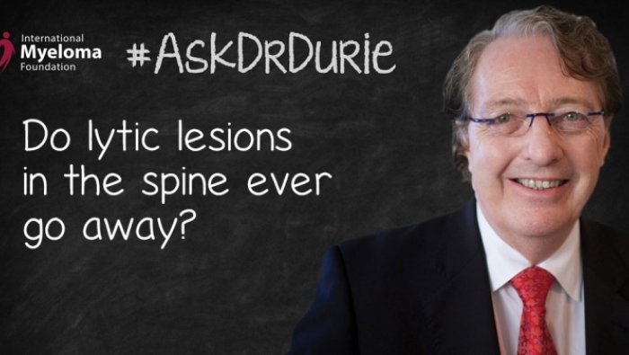 Dr. Durie in front of a chalk board