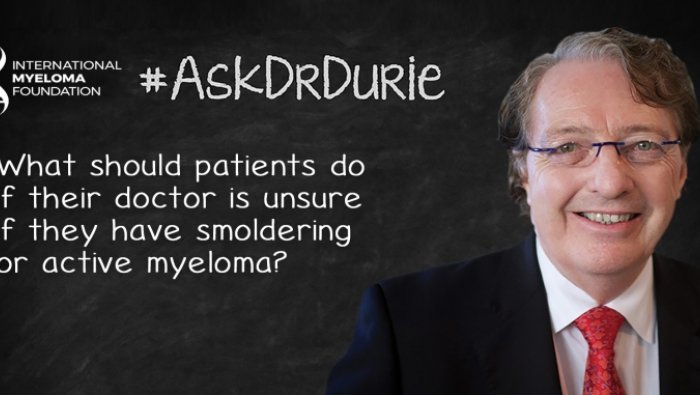Dr. Durie in front of a chalk board
