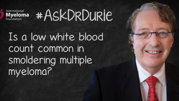 Dr. Durie in front of a chalk board